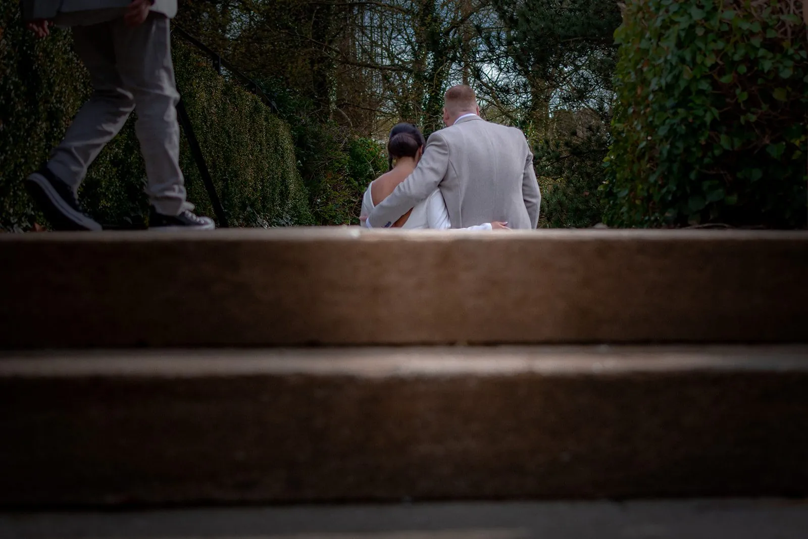 Newlyweds on weathered stone steps, texture-led portraiture that suits a farm conversion